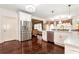 Spacious kitchen offers white cabinetry, stainless steel appliances, and hardwood floors at 3332 Heathchase Ln, Suwanee, GA 30024