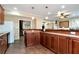 Kitchenette offering dark wooden cabinets, granite counters, and an open design at 3332 Heathchase Ln, Suwanee, GA 30024