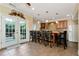 Kitchenette featuring a bar with stools and French doors to the outside at 3332 Heathchase Ln, Suwanee, GA 30024