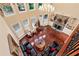 Grand living room with stone fireplace, large windows, chandelier, and hardwood floors at 3332 Heathchase Ln, Suwanee, GA 30024