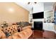 Cozy living room showcases plush sofas, built-in shelving, fireplace, and gleaming hardwood floors at 3332 Heathchase Ln, Suwanee, GA 30024