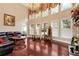 Bright living room with high ceilings, a chandelier, large windows, and elegant furnishings at 3332 Heathchase Ln, Suwanee, GA 30024