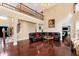 Elegant living room featuring soaring ceilings, gleaming hardwood floors, and a grand chandelier at 3332 Heathchase Ln, Suwanee, GA 30024