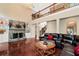 Spacious living room boasting a stone fireplace, hardwood floors, and an elegant chandelier at 3332 Heathchase Ln, Suwanee, GA 30024