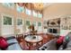 Expansive living room featuring a fireplace, chandelier, plush seating, and elegant decor at 3332 Heathchase Ln, Suwanee, GA 30024