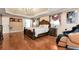 Elegant main bedroom with hardwood floors, a chandelier, tray ceilings and sitting area at 3332 Heathchase Ln, Suwanee, GA 30024