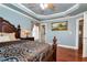 Comfortable main bedroom with an ornate bed, ceiling fan, and picture on wall at 3332 Heathchase Ln, Suwanee, GA 30024