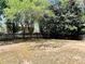 Large backyard behind a home with wood fence, grass, and a variety of trees at 415 Wood Trace Ct, Alpharetta, GA 30022