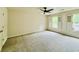 Expansive bedroom with ceiling fan, plush carpet, and bright windows with shutters at 415 Wood Trace Ct, Alpharetta, GA 30022
