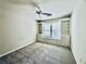 Bright bedroom with cozy carpet, ceiling fan, and built-in shelves with drawers and cabinets at 415 Wood Trace Ct, Alpharetta, GA 30022