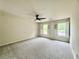 Bright bedroom featuring a ceiling fan, cozy carpet, and charming white shutters at 415 Wood Trace Ct, Alpharetta, GA 30022