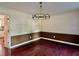 Formal dining room featuring two-tone paint, hardwood floors, and decorative lighting at 415 Wood Trace Ct, Alpharetta, GA 30022