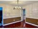 Formal dining room featuring hardwood floors and decorative wall paneling at 415 Wood Trace Ct, Alpharetta, GA 30022
