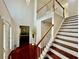 Inviting foyer with hardwood floors, staircase, and view into adjacent rooms at 415 Wood Trace Ct, Alpharetta, GA 30022