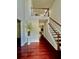 Grand foyer with hardwood floors, stairs and a second floor balcony overlooking the entry at 415 Wood Trace Ct, Alpharetta, GA 30022