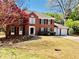 Traditional brick two-story home with black shutters, manicured lawn, and an attached three-car garage at 415 Wood Trace Ct, Alpharetta, GA 30022