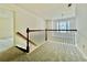Second-floor hallway with window views and neutral carpeting at 415 Wood Trace Ct, Alpharetta, GA 30022