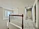 Upstairs hallway with wood railing, bright windows, and neutral carpet throughout at 415 Wood Trace Ct, Alpharetta, GA 30022