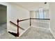 Upstairs hallway with cozy carpeting, a chandelier and white railing at 415 Wood Trace Ct, Alpharetta, GA 30022