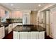 Modern kitchen featuring white cabinets, a center island with a stovetop, and dark countertops at 415 Wood Trace Ct, Alpharetta, GA 30022
