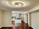 Open-concept kitchen with a large island, white cabinets, and modern lighting fixture above at 415 Wood Trace Ct, Alpharetta, GA 30022