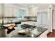Modern kitchen featuring black granite countertops, a kitchen island, and stainless steel appliances at 415 Wood Trace Ct, Alpharetta, GA 30022