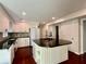 Spacious kitchen featuring a center island, white cabinets, granite countertops, and stainless steel appliances at 415 Wood Trace Ct, Alpharetta, GA 30022