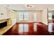 Open living room boasts a fireplace, built-in shelving, hardwood floors, and a door leading to the outside at 415 Wood Trace Ct, Alpharetta, GA 30022