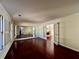 Elegant living room boasts gleaming wood floors, a wall mirror, and access to other rooms at 415 Wood Trace Ct, Alpharetta, GA 30022