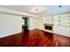 Bright living room featuring a fireplace, built-in shelving, and glossy hardwood floors at 415 Wood Trace Ct, Alpharetta, GA 30022