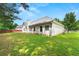 Exterior view of backyard featuring vibrant green grass, fence in background and back of the house at 85 Old Gettysburg Way, Dallas, GA 30157