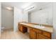 Bright bathroom features double sinks with wooden cabinets and a large mirror with vanity lights, plus separate toilet and shower room at 85 Old Gettysburg Way, Dallas, GA 30157