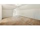 Spacious bonus room with neutral carpet, white walls, and a window providing natural light and backyard view at 85 Old Gettysburg Way, Dallas, GA 30157