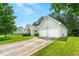 View of the home's exterior with a two-car garage, attractive lawn, and a concrete driveway at 85 Old Gettysburg Way, Dallas, GA 30157