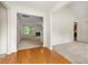 Open-concept living room features neutral carpet, a fireplace, and an adjacent entry area with wood floors at 85 Old Gettysburg Way, Dallas, GA 30157