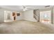 Spacious open living room featuring neutral walls, carpet, and access to other rooms at 85 Old Gettysburg Way, Dallas, GA 30157