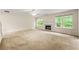 Spacious living room with a fireplace, carpet flooring, neutral wall paint, and multiple windows at 85 Old Gettysburg Way, Dallas, GA 30157