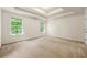 Spacious main bedroom with tray ceiling, neutral carpet and natural light at 85 Old Gettysburg Way, Dallas, GA 30157