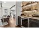Stylish bar area with stone backsplash, floating shelves, and a wine refrigerator at 1241 Hightower Nw Xing, Marietta, GA 30060