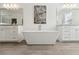 Bright bathroom with a freestanding tub between two vanities and tiled floors at 1241 Hightower Nw Xing, Marietta, GA 30060