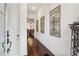 Elegant entryway with hardwood floors, decorative wall art, and a glimpse into the dining area at 1241 Hightower Nw Xing, Marietta, GA 30060
