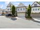 Attractive townhome facade with a two-car garage, complemented by lush green landscaping at 1241 Hightower Nw Xing, Marietta, GA 30060
