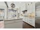 Bright kitchen featuring white cabinets, stainless steel appliances, and a large island with a marble countertop at 1241 Hightower Nw Xing, Marietta, GA 30060