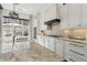 Bright kitchen featuring white cabinets, stainless steel appliances, and a large island with a marble countertop at 1241 Hightower Nw Xing, Marietta, GA 30060