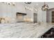 Bright kitchen featuring white cabinets, stainless steel appliances, and a large island with a marble countertop at 1241 Hightower Nw Xing, Marietta, GA 30060