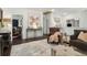 Sitting area with leather chair, velvet sofa, accent wall, and an area leading to another room at 1241 Hightower Nw Xing, Marietta, GA 30060