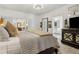 Spacious main bedroom features a TV, access to other rooms and elegant furnishings at 1241 Hightower Nw Xing, Marietta, GA 30060