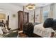 Elegant main bedroom featuring a four-poster bed, dark wood accents, designer lighting, and stylish decor at 1241 Hightower Nw Xing, Marietta, GA 30060
