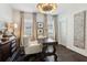 Bright home office featuring hardwood floors, large desk, and stylish decor with decorative curtains on the windows at 1241 Hightower Nw Xing, Marietta, GA 30060