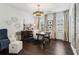 Well-lit home office with dark wood floors, stylish furniture, designer lighting, and decorative wall art at 1241 Hightower Nw Xing, Marietta, GA 30060